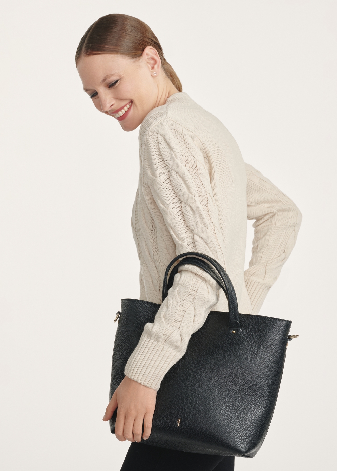 Czarna skórzana torebka shopper TORES-0728D-99(Z25), widok produktu przodem na modelce, widoczne pół sylwetki.