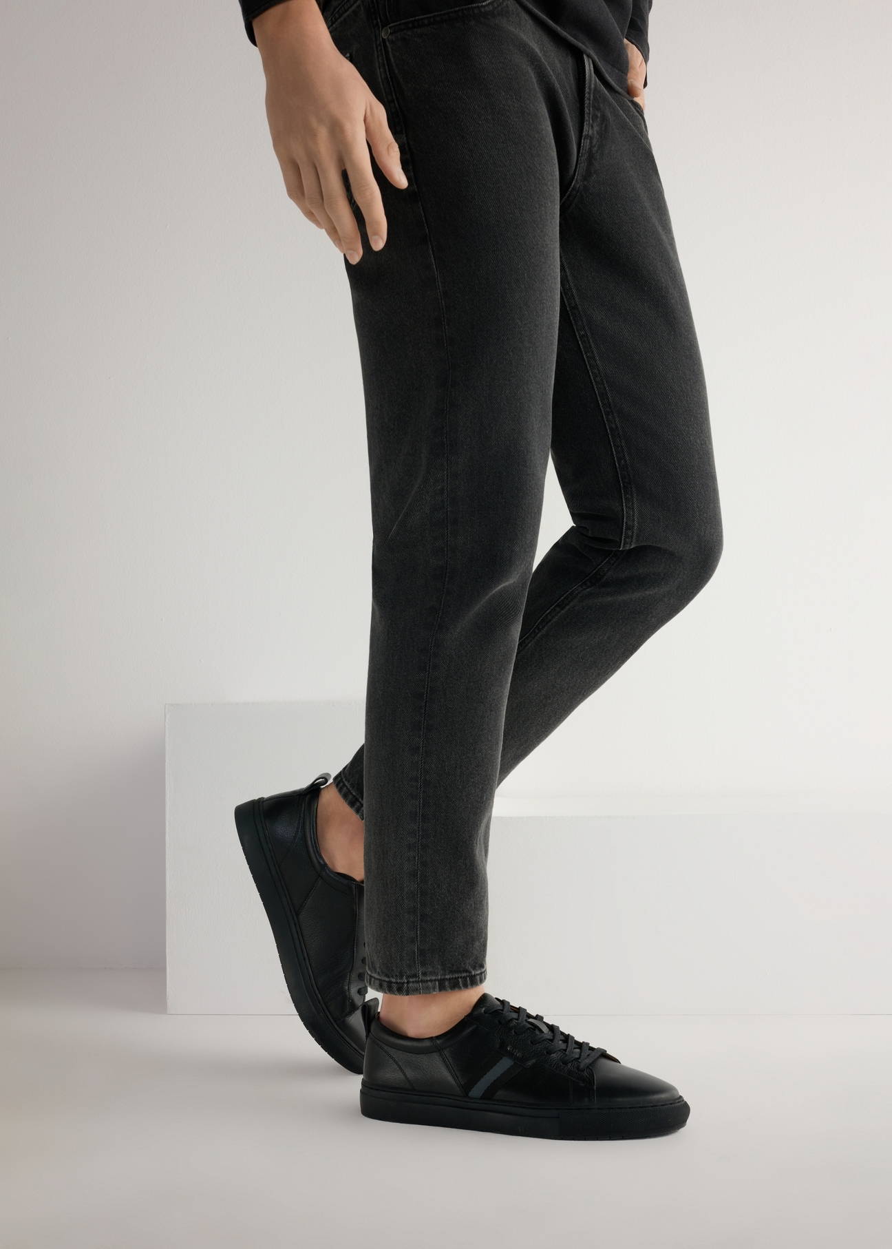 Czarne skórzane buty męskie BUTYM-0430A-99(W25), widok produktu od boku na modelu, widoczna połowa sylwetki.