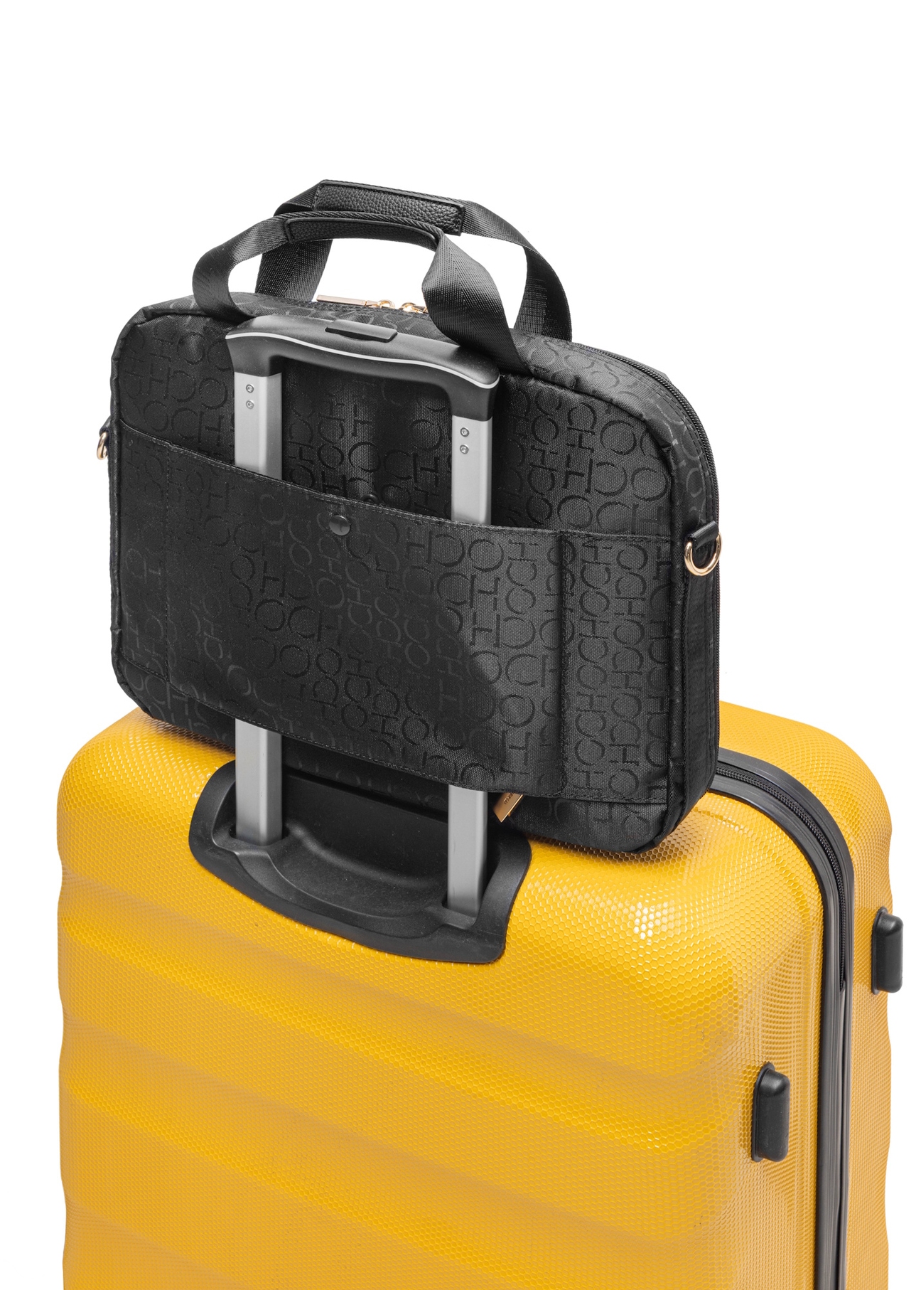 Czarna torba damska z monogramem TOREN-0299-99(W25), widok produktu na walizce na białym tle.