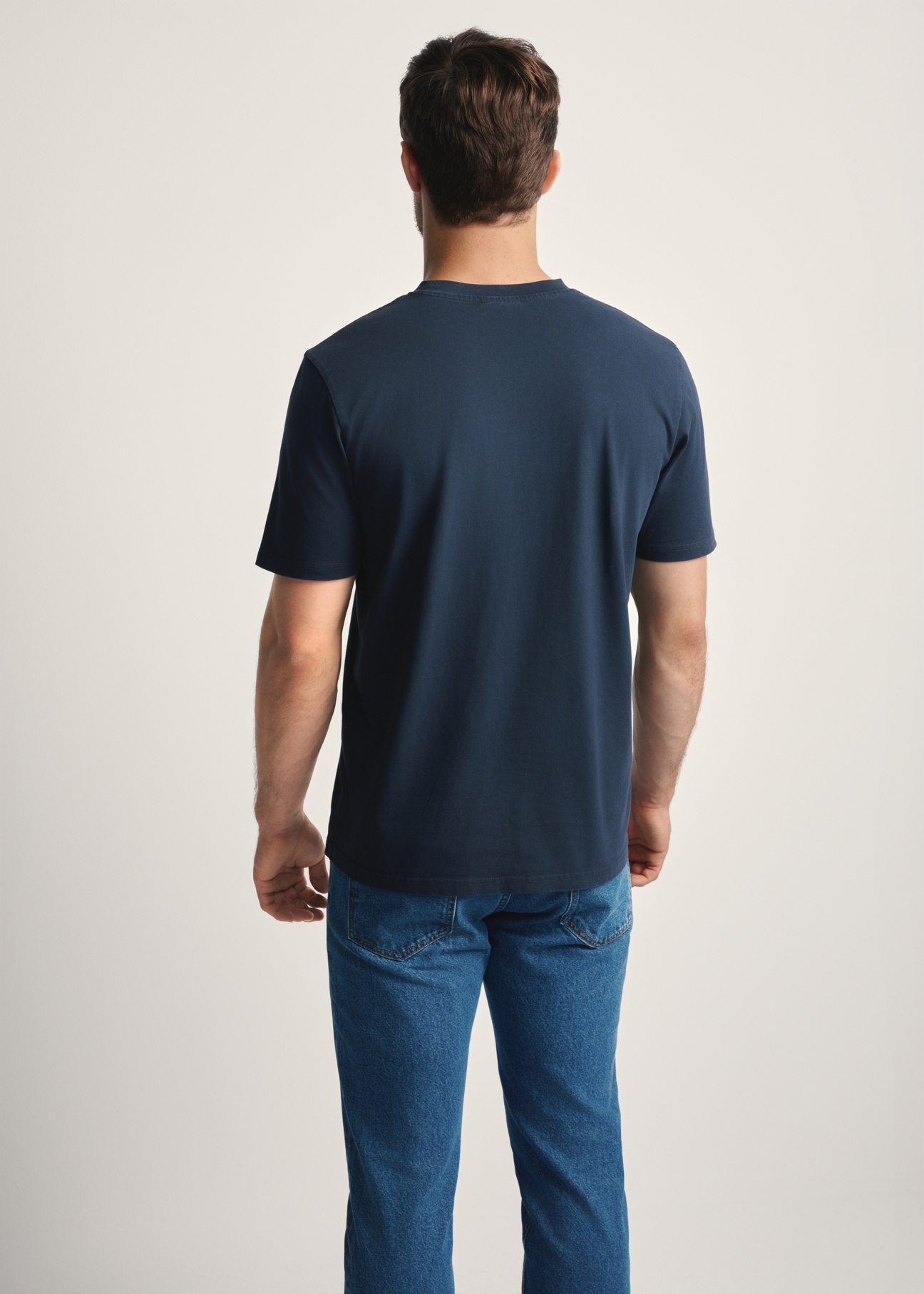 T-shirt męski w kolorze granatowym TSHMT-0134-68(Z25), widok produktu z tyłu na modelu. Widoczna połowa sylwetki.