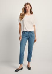 Ciemnoniebieskie spodnie jeansowe damskie JEADT-0011-7C(W26), widok produktu z przodu na modelce. Widoczna cała sylwetka.