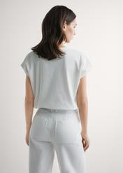 Kremowy T-shirt damski z nadrukiem TSHDT-0160-0B(W26), widok produktu z tyłu na modelce. Widoczna połowa sylwetki.