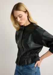 Czarna skórzana kurtka damska KURDS-0570-99(W26), widok produktu z boku na modelce. Widoczna połowa sylwetki.