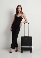 Walizka mała na kółkach WALNY-0044-99-19(W26), widok produktu z przodu obok sylwetki modelki.