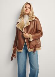 Brązowy krótki kożuch damski KOZDP-0001A-89(Z25), widok produktu przodem na modelce, widoczna połowa sylwetki.