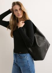 Czarna skórzana torebka shopper TORES-1372-9I(Z26), widok produktu skosem na modelce. Widoczna połowa sylwetki.
