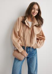 Mała różowa skórzana torebka damska TORES-0466E-5D(W26), widok produktu od przodu na modelce, widoczna połowa sylwetki.