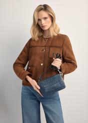 Mała granatowa skórzana torebka croco TORES-1231-7D(W26), widok produktu w rękach modelki. Widoczna połowa sylwetki.