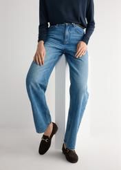 Brązowe zamszowe mokasyny damskie BUTYD-1257-1I(W26), widok produktu na stopach modelki na jasnym tle.