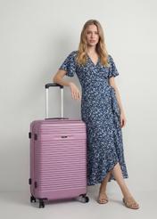 Walizka duża na kółkach WALAB-0040-5B-28(W26), widok produktu skosem przy modelce, widoczna cała sylwetka.