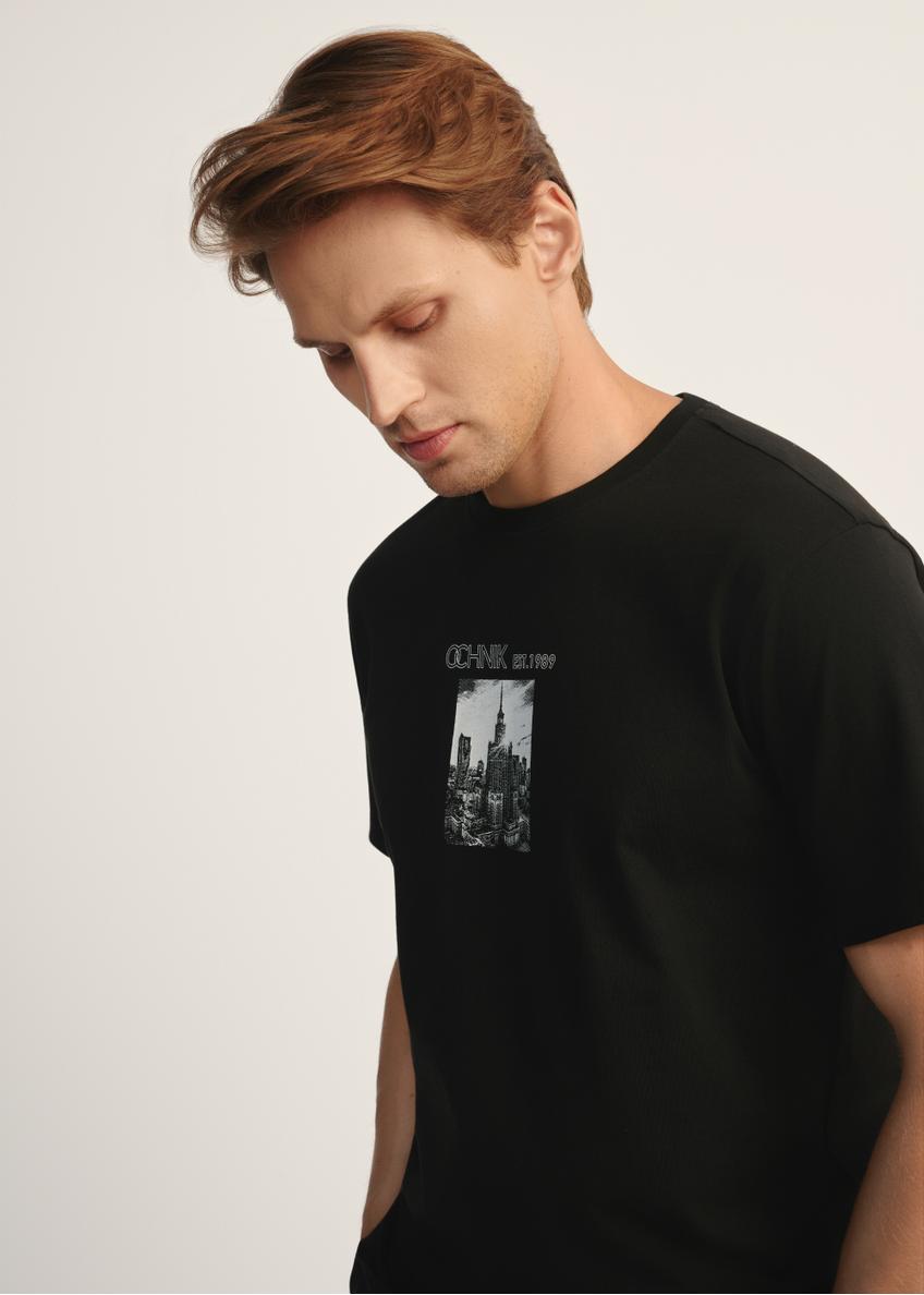 Czarny T-shirt męski z nadrukiem TSHMT-0132-99(Z25), widok produktu skosem na modelu, widoczna połowa sylwetki.
