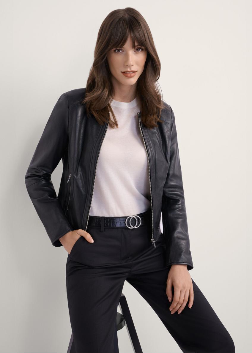 Czarna krótka kurtka skórzana damska KURDS-0294-99(KS), widok produktu z przodu na modelce. Widoczna połowa sylwetki.